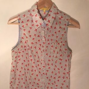 Sleeveless white blouse with orange birds